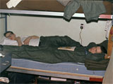 Wooley and Stucker in the barracks recovering from a hard day at the bomb dump. 