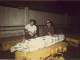 Steve Linebarger and Chuck Schabel next to a trainer CBU-2 that they demilitarized.