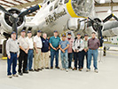 The guys pose in front of the B-17 on display (L-R): Chuck Schabel, Craig Meyers, Sam Bothern, Paul Baker, Museum volunteer, Bill Woodward, Steve Bisel, Steve Carr, Bob Roberts & Jim Jenkins