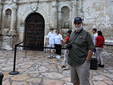 Steve Bisel poses in front of the iconic Alamo