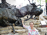 Esperanza Miller poses by a sculpture along the river